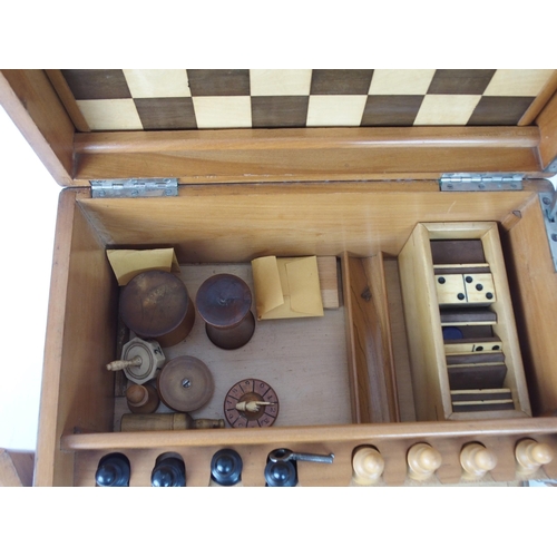 626 - A VICTORIAN GAMES COMPENDIUMwith hinged lid and twin flap doors, with associated chess pieces, draug... 