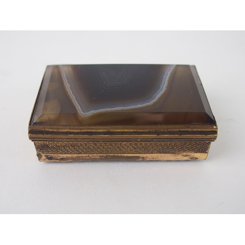 643 - A GILT-METAL AND AGATE SEAL BOXwith hinged lid and side, the side opening to reveal candle holder wi... 