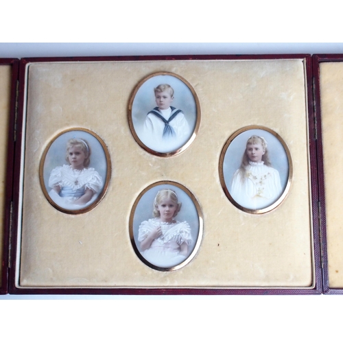 652 - A FAMILY GROUP OF PAINTED OVAL PORTRAIT MINIATUREScomprising three girls and one boy, 7 x 5.5cm, in ... 