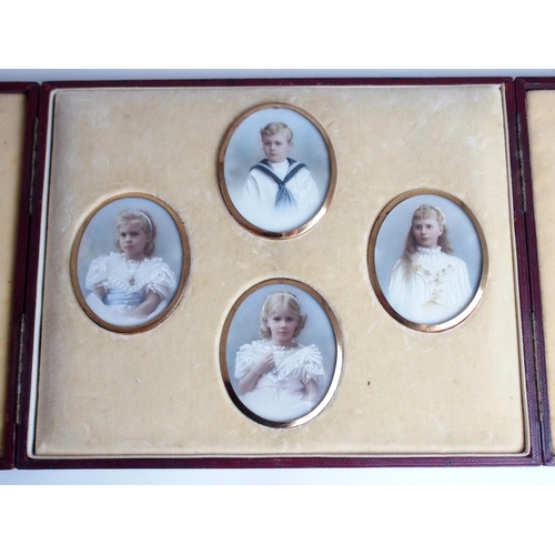 652 - A FAMILY GROUP OF PAINTED OVAL PORTRAIT MINIATUREScomprising three girls and one boy, 7 x 5.5cm, in ... 