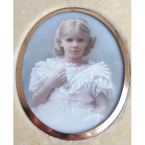 652 - A FAMILY GROUP OF PAINTED OVAL PORTRAIT MINIATUREScomprising three girls and one boy, 7 x 5.5cm, in ... 