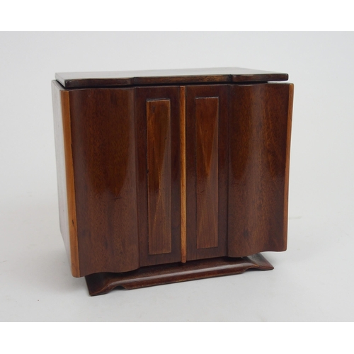 660 - AN ART DECO SPECIMAN WOOD SERPENTINE TEA CADDYmodeled as a sideboard with shaped inlaid hinged lid a... 