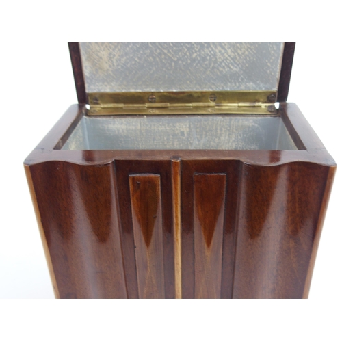 660 - AN ART DECO SPECIMAN WOOD SERPENTINE TEA CADDYmodeled as a sideboard with shaped inlaid hinged lid a... 