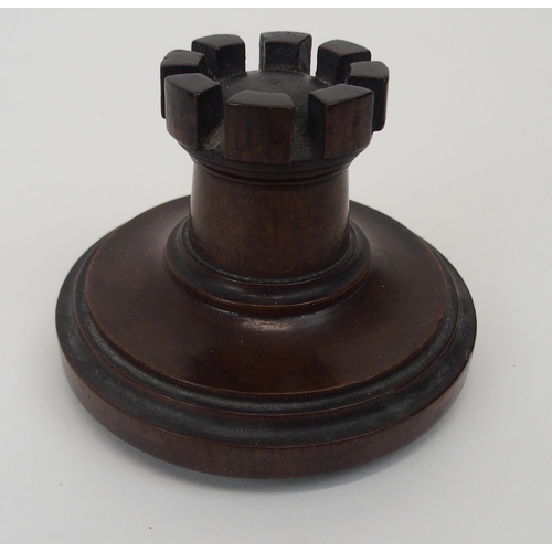 666 - A MAHOGANY TURRET TOBACCO JARof circular form with castellations, removable lid, 20cm high... 