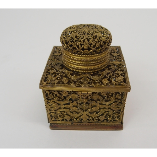 670 - A FRENCH FILIGREE GILT-METAL TRAVEL INKWELLwith collapsible sides opening to reveal, candle holder, ... 