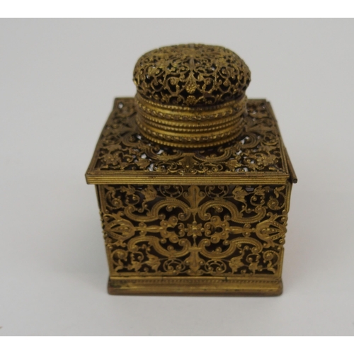 670 - A FRENCH FILIGREE GILT-METAL TRAVEL INKWELLwith collapsible sides opening to reveal, candle holder, ... 