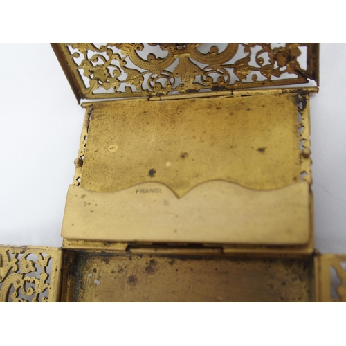 670 - A FRENCH FILIGREE GILT-METAL TRAVEL INKWELLwith collapsible sides opening to reveal, candle holder, ... 