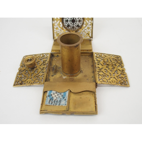 670 - A FRENCH FILIGREE GILT-METAL TRAVEL INKWELLwith collapsible sides opening to reveal, candle holder, ... 