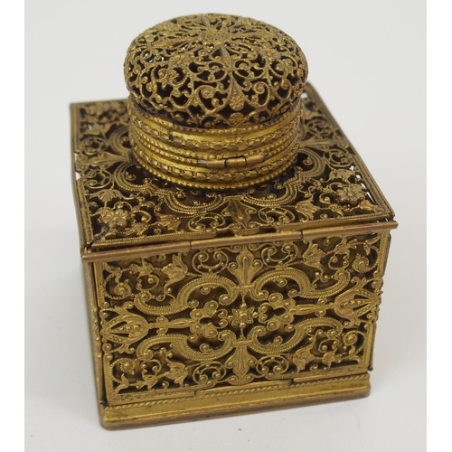 670 - A FRENCH FILIGREE GILT-METAL TRAVEL INKWELLwith collapsible sides opening to reveal, candle holder, ... 