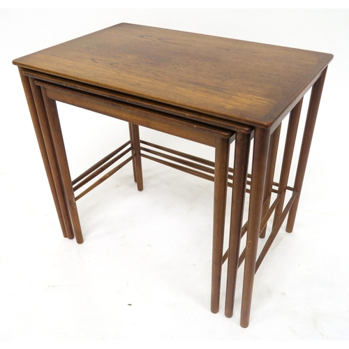 114 - A MID 20TH CENTURY POUL JEPPESEN, DENMARK TEAK NEST OF THREE TABLESwith rectangular tops on stretche... 