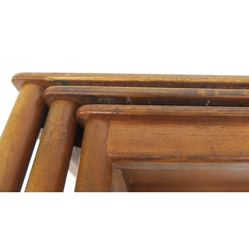 114 - A MID 20TH CENTURY POUL JEPPESEN, DENMARK TEAK NEST OF THREE TABLESwith rectangular tops on stretche... 