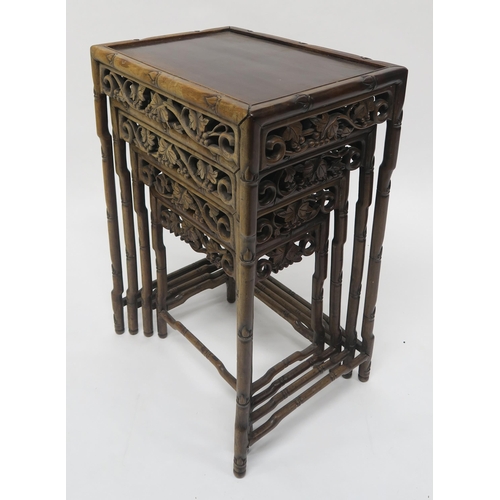20 - A 19TH CENTURY CHINESE FAUX BAMBOO HARDWOOD NEST OF FOUR TABLESwith carved foliate fretwork friezes,... 