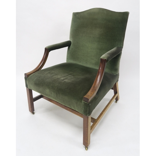 28 - A GEORGIAN MAHOGANY FRAMED OPEN ARMCHAIRwith green upholstery on stretchered square chamfered suppor... 