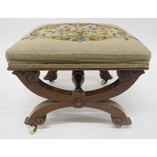 34 - A VICTORIAN WALNUT FRAMED TAPESTRY UPHOLSTERED FOOTSTOOLon two X-frame supports joined by turned str... 