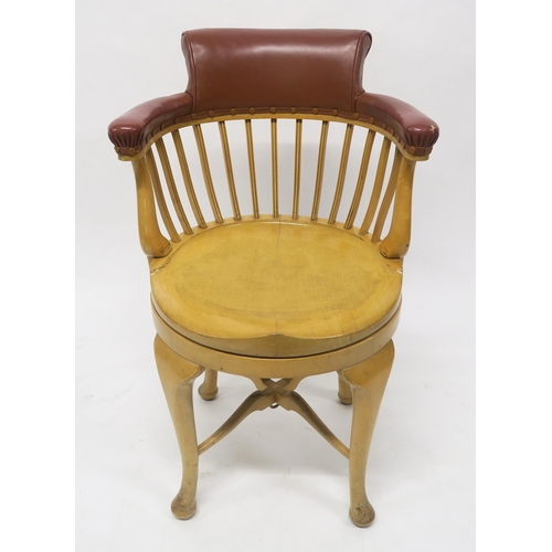 39 - A CAPTAINS BEECH REVOLVING SHIPS ARMCHAIR CHAIRwith brown vinyl upholstered comb back on stretchered... 