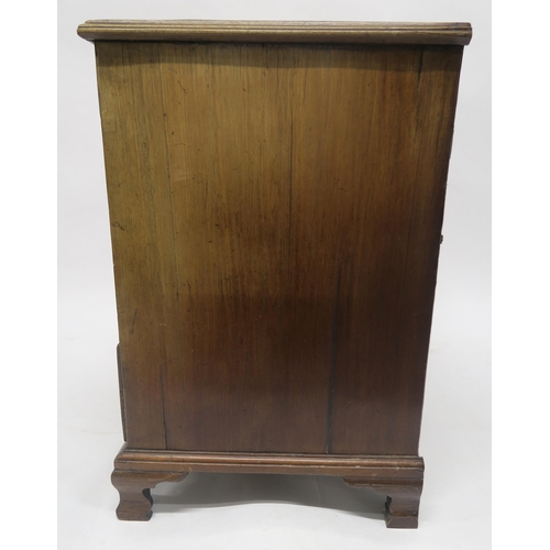 41 - A GEORGIAN MAHOGANY AND WALNUT VENEERED KNEEHOLE DESKwith one long drawer above two banks of three d... 