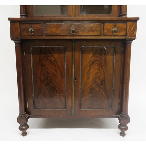 42 - A 19TH CENTURY MAHOGANY GLAZED BOOKCASE ON CABINET BASEwith two glazed doors flanked by columns abov... 
