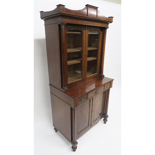 42 - A 19TH CENTURY MAHOGANY GLAZED BOOKCASE ON CABINET BASEwith two glazed doors flanked by columns abov... 