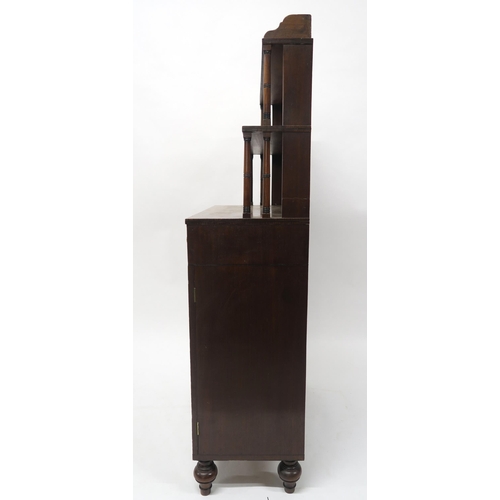 43 - A19TH CENTURY MAHOGANY CABINETwith two open book shelves above two drawers above two panel doors on ... 
