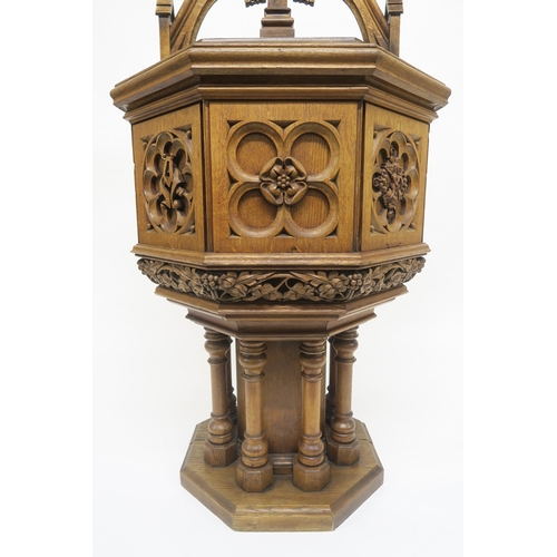50 - A PUGINESQUE OAK OCTAGONAL BAPTISMAL FONTwith architectural style oak font cover concealing stone ba... 