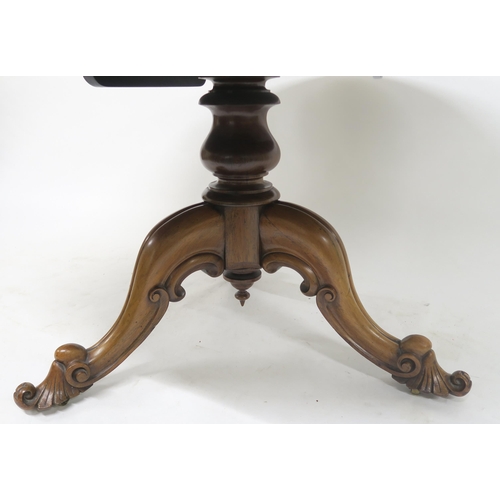 52 - A VICTORIAN ROSEWOOD OVAL TILT TOP BREAKFAST TABLEon a pedestal tripod base with carved scroll feet,... 