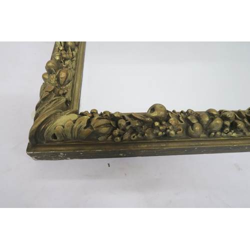 55 - A 19TH CENTURY GILTWOOD AND GESSO RECTANGULAR WALL MIRRORwith foliage and fruit decorated frame surr... 