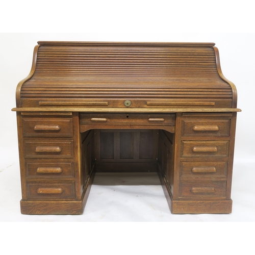 62 - AN EARLY 20TH CENTURY OAK MAPLE & CO LONDON & PARIS TAMBOUR FRONT TWIN PEDESTAL DESKwith tam... 