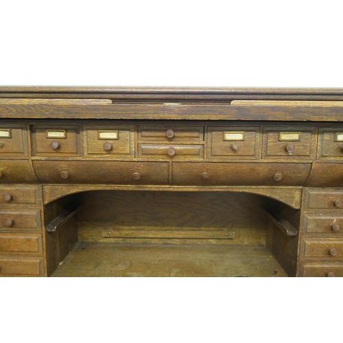 62 - AN EARLY 20TH CENTURY OAK MAPLE & CO LONDON & PARIS TAMBOUR FRONT TWIN PEDESTAL DESKwith tam... 