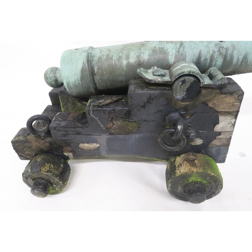 64 - A BRONZE CANNON ON WOODEN CARRIAGE76cm high (on carriage) x 116cm long (on carriage) x 63cm wide (ca... 