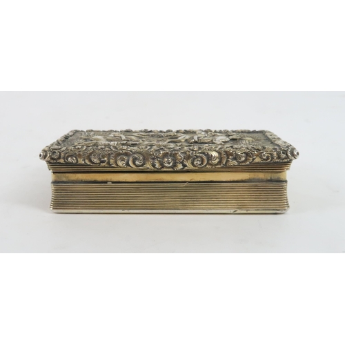 453 - A GEORGIAN SILVER GILT SNUFF BOXof rectangular form, the cover with a relief fox hunting scene surro... 