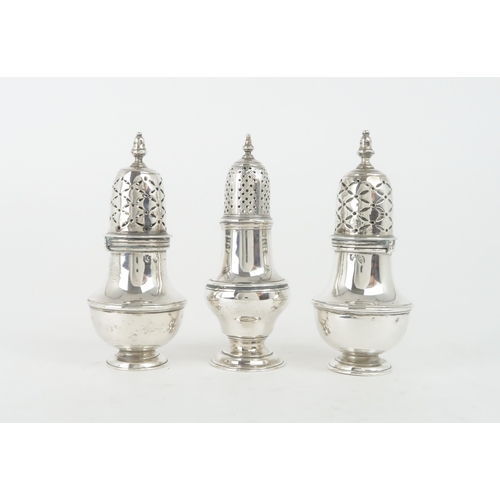 457 - A PAIR OF GEORGE I IRISH SILVER CASTERSof plain baluster form with cross pierced covers and acorn fi... 