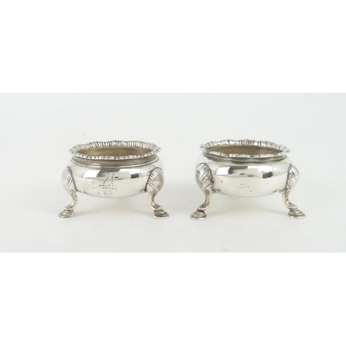 461 - A GEORGE II SCOTTISH SILVER SALTof cauldron shape with flaring reeded rim upon three hoof feet, with... 