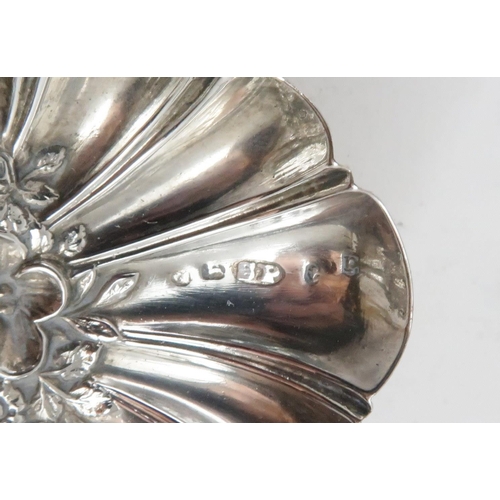 463 - A GEORGE III SILVER CADDY SPOONthe bowl in the form of a shell with chased floral decoration and mot... 