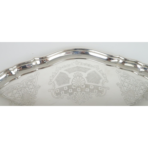 470 - AN IMPRESSIVE GEORGE V SILVER TWIN HANDLED SERVING TRAYof oval form with Chippendale style pie crust... 