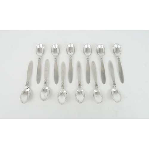 475 - A SET OF TWELVE GEORG JENSEN SILVER COFFEE SPOONSin the cactus pattern, with import marks for London... 