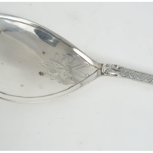 478 - AN ALEXANDER RITCHIE SPOON the petal shaped bowl engraved with celtic style decoration continuing on... 