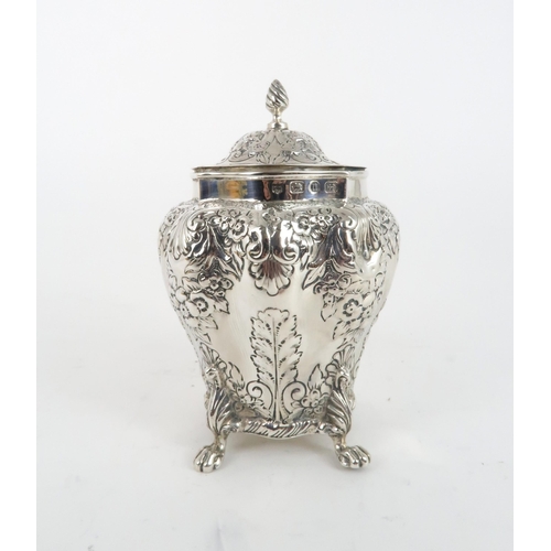 494 - A LATE VICTORIAN SILVER TEA CADDYof bombe form, with repousse scrolling floral and shell decoration ... 