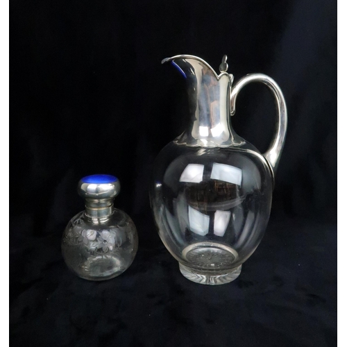 495 - A SILVER TOPPED GLASS CLARET JUGof ovoid form, the silver spout and neck with pie crust edges and cl... 