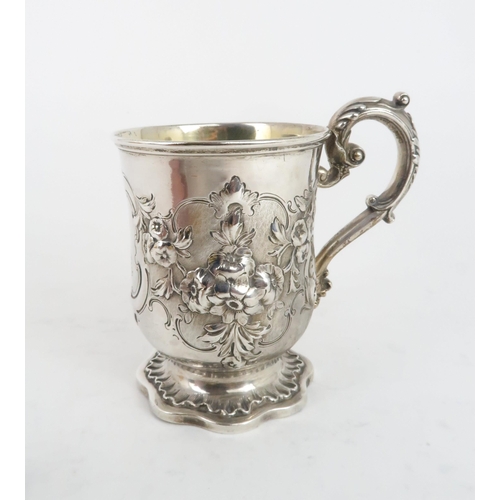 503 - A VICTORIAN SILVER GILT MUGof slightly flared form, with repousse decoration of flowers and foliage,... 