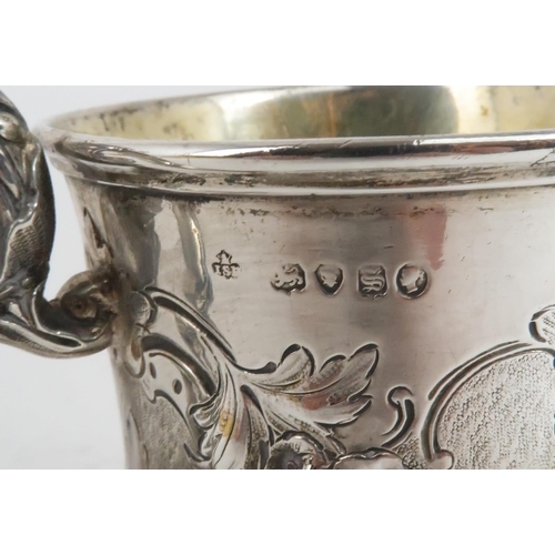 503 - A VICTORIAN SILVER GILT MUGof slightly flared form, with repousse decoration of flowers and foliage,... 