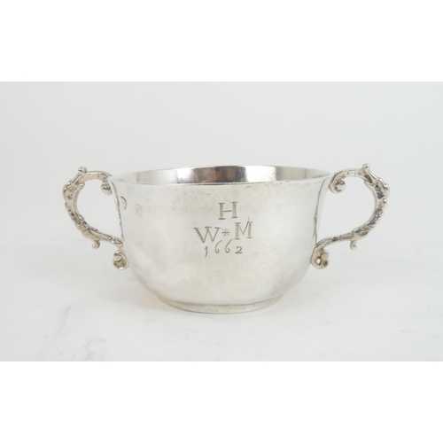 506 - A CHARLES II TWIN HANDLED SILVER PORRINGER the plain form bowl with slightly everted rim and engrave... 