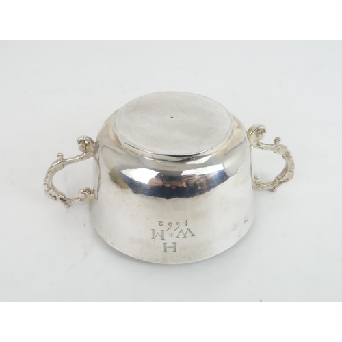 506 - A CHARLES II TWIN HANDLED SILVER PORRINGER the plain form bowl with slightly everted rim and engrave... 