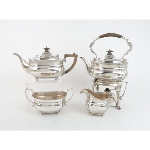 509 - A GEORGE V FOUR PIECE SILVER TEA SERVICEcomprising a spirit kettle and stand, teapot, sugar bowl and... 