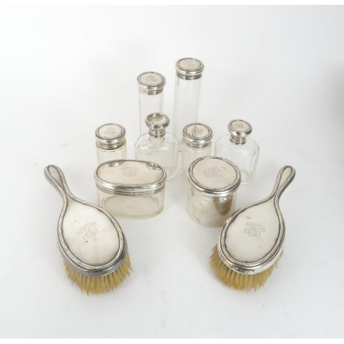 510 - AN EDWARDIAN SILVER AND CUT GLASS LADIES DRESSING SETcomprising vanity jars, clothes brushes, hair b... 