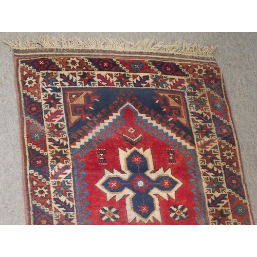 135 - A RED GROUND TURKISK DOSEMEALTI RUNNERwith multicoloured geometric medallions, dark blue spandrels a... 