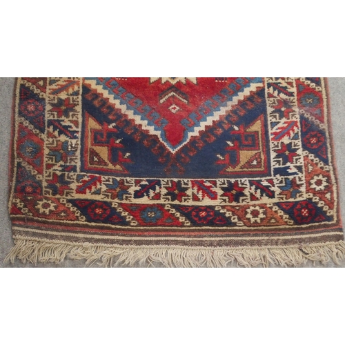 135 - A RED GROUND TURKISK DOSEMEALTI RUNNERwith multicoloured geometric medallions, dark blue spandrels a... 