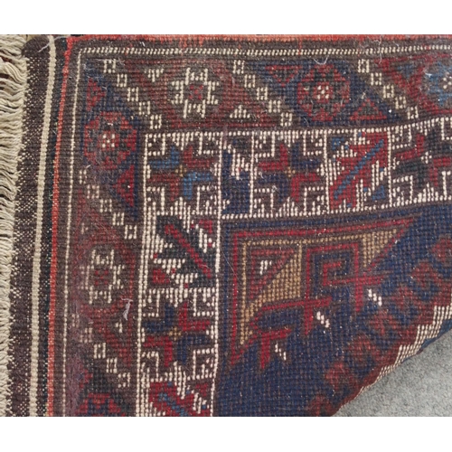 135 - A RED GROUND TURKISK DOSEMEALTI RUNNERwith multicoloured geometric medallions, dark blue spandrels a... 