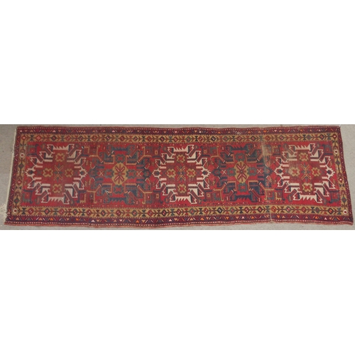 136 - A RED GROUND KARADJA RUNNERwith five geometric medallions and beige borders, 317cm long x 94cm wide... 