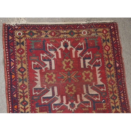 136 - A RED GROUND KARADJA RUNNERwith five geometric medallions and beige borders, 317cm long x 94cm wide... 