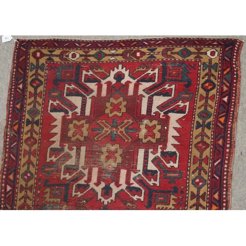 136 - A RED GROUND KARADJA RUNNERwith five geometric medallions and beige borders, 317cm long x 94cm wide... 